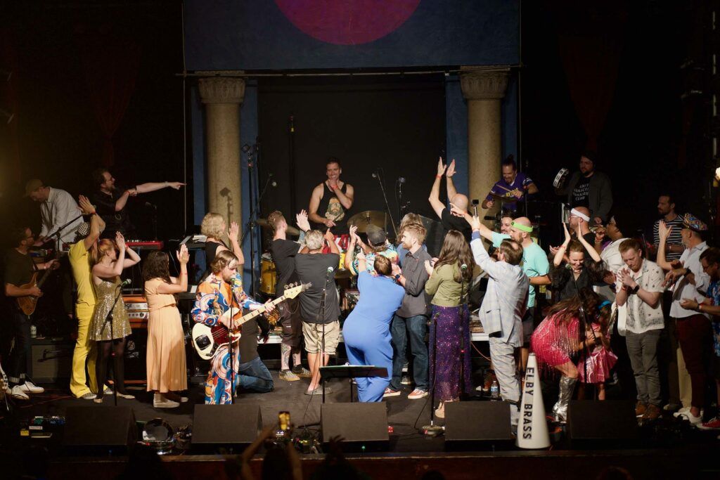 The Frostapalooza band on stage applauding Ian