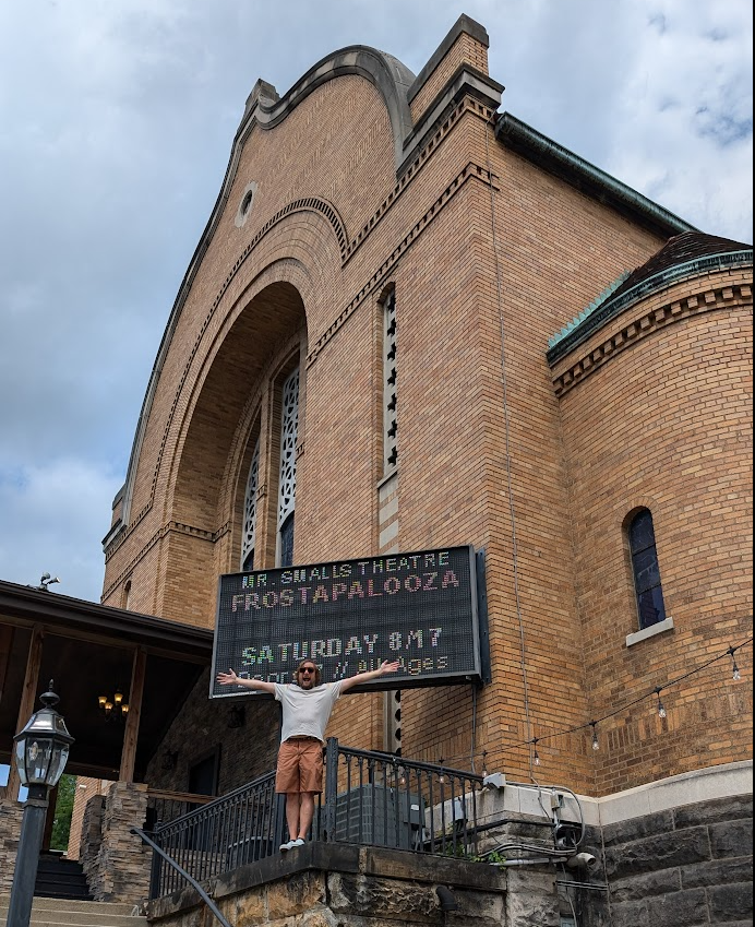 Brad posing in front of Mr Smalls Theatre with marquee that reads 