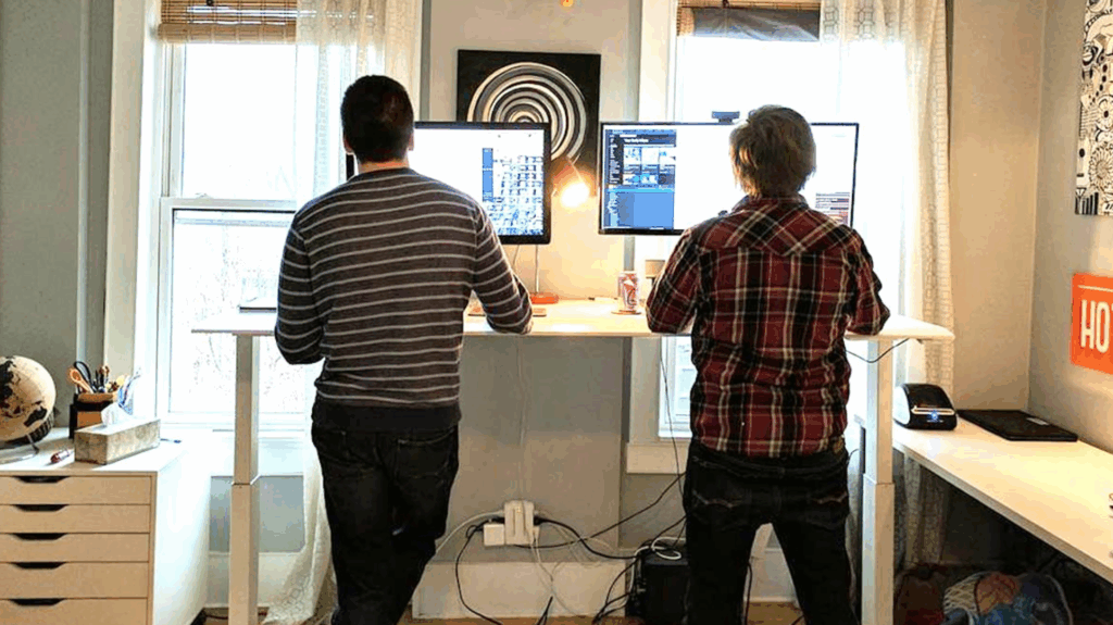 Brad and Ian at a shared standing desk